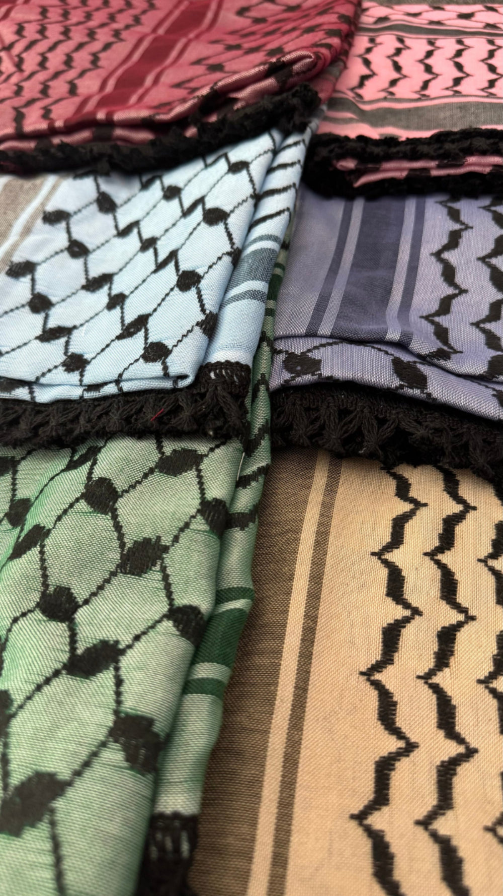 Collection of patterned scarves in various colors and designs.