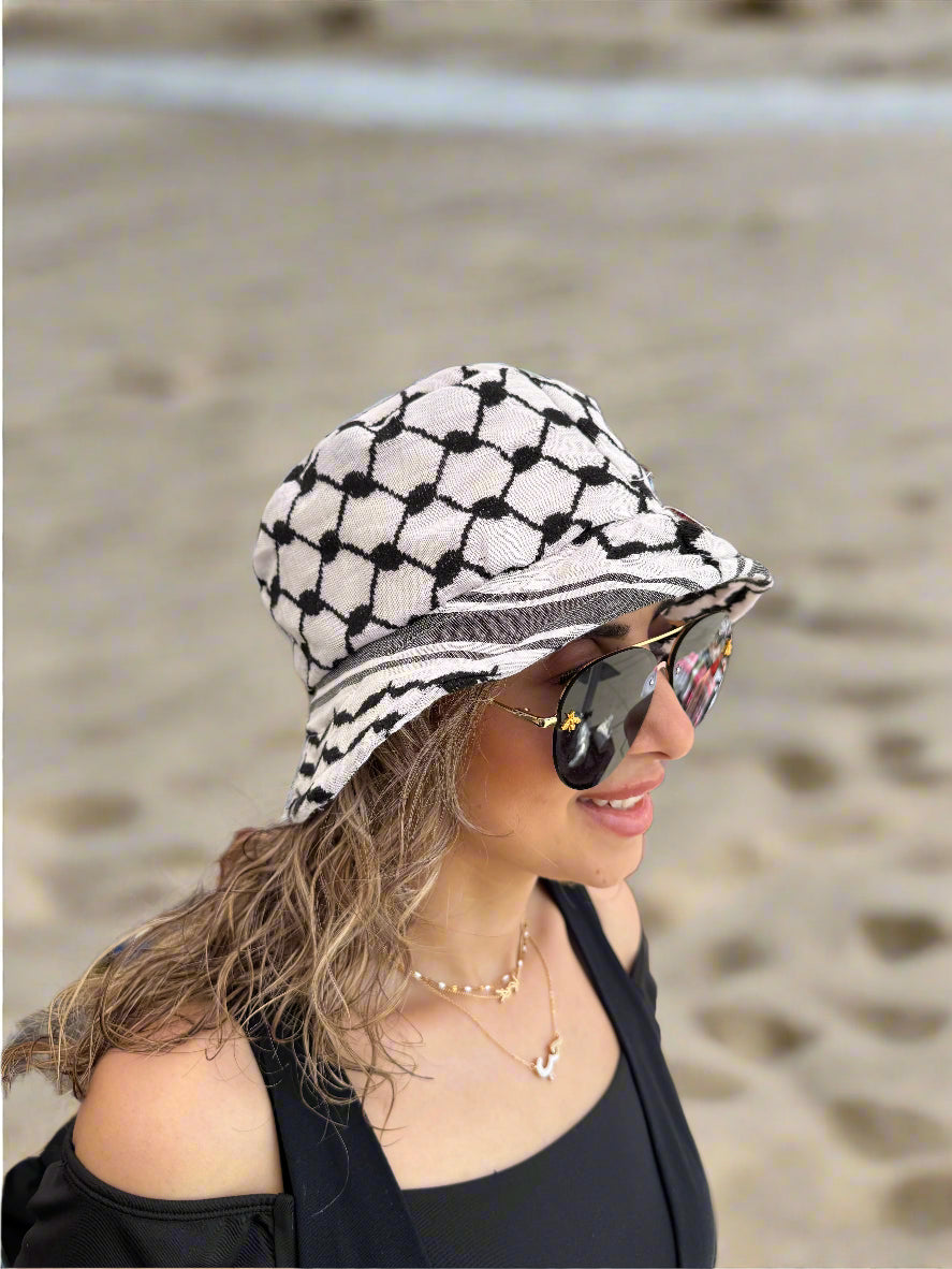Woman wearing a black and white kufiyya bucket hat