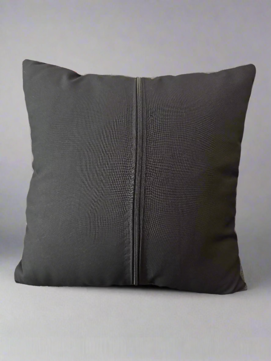 back of a pillowcase with a zipper on a light gray background