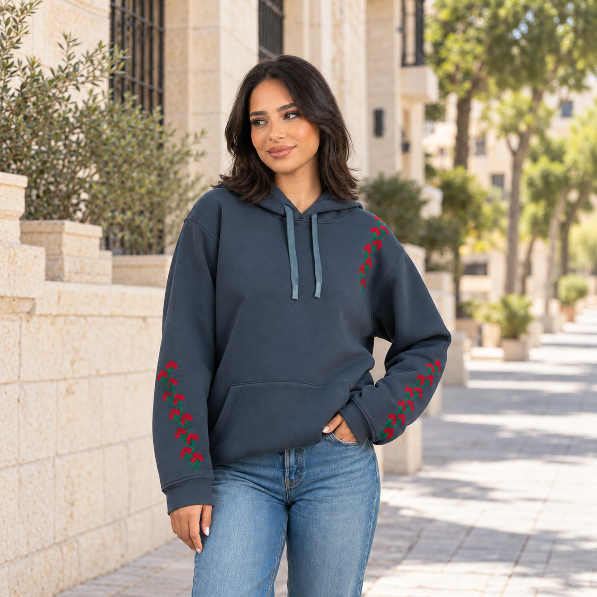 Jouri Hand-Stitched Hoodie on model in a limestone neighborhood