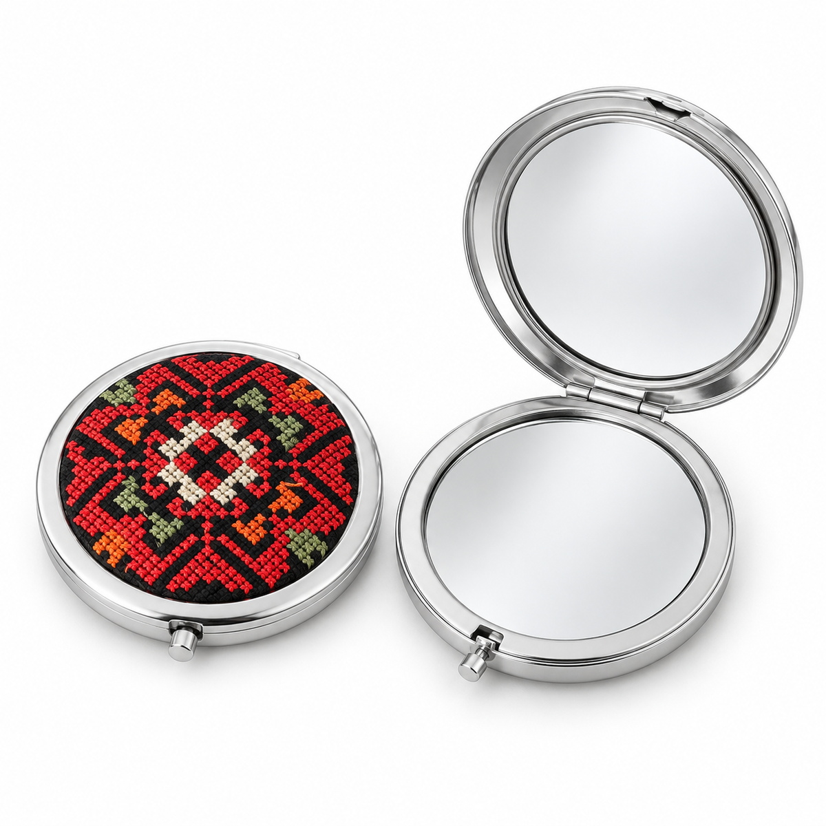 Representative red-dominant tatreez pocket mirror shown closed beside an open mirror on a white background. Sold individually; patterns and colours vary.